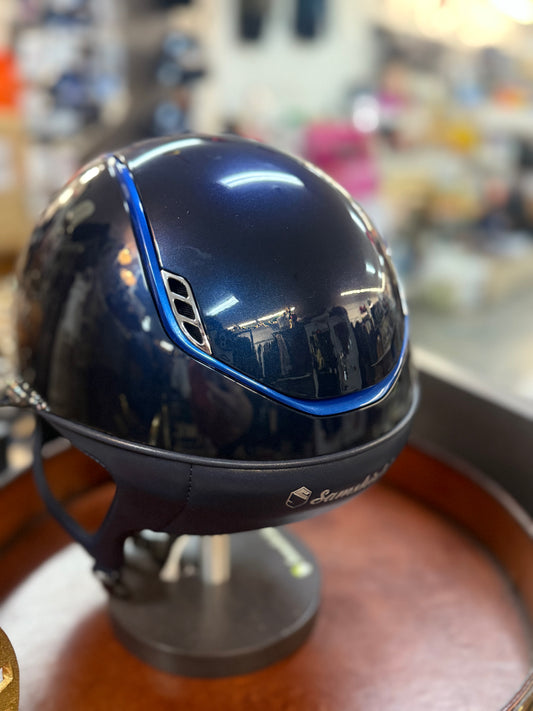 Blue helmet with blue rim on a stand in a store setting
