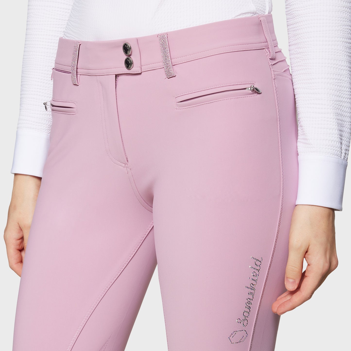 Pink riding pants with a brand logo on a white background