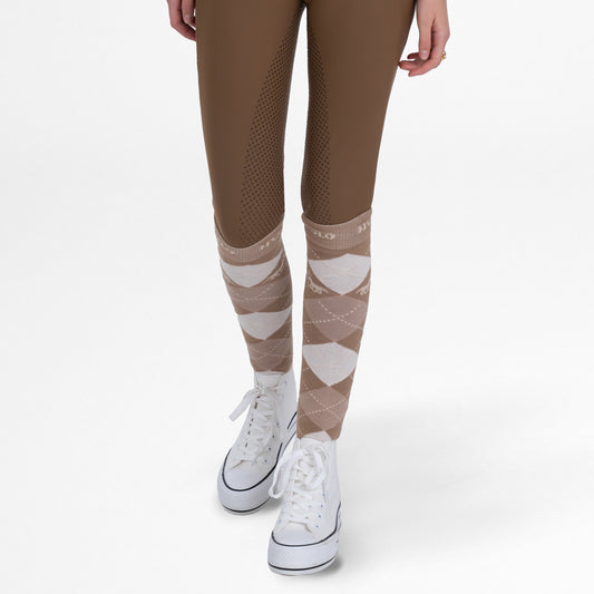 Brown leggings with patterned socks worn by a person on a white background