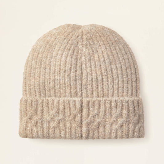 Beige knit beanie on a light beige background