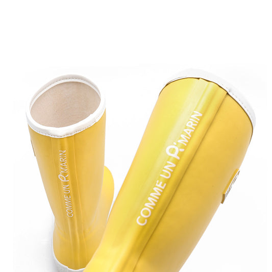 Yellow children's wellies with french writing on a white background