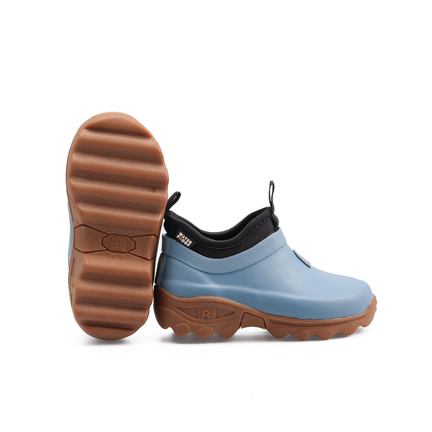 Blue rubber clog shoe with brown sole on a white background