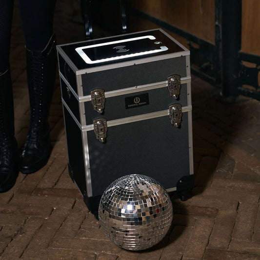 Black and silver grooming case with a disco ball on a wooden floor