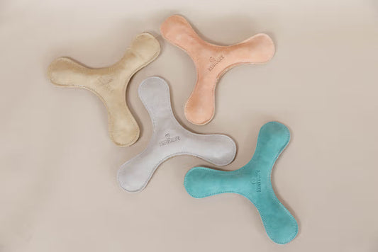 Four colorful toys shaped like a 'Y' on a beige background