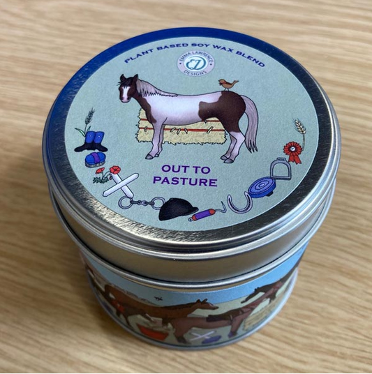 Candle tin with horse-themed design on a wooden surface