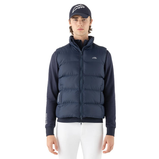 Person wearing a navy puffer vest and white pants on a white background