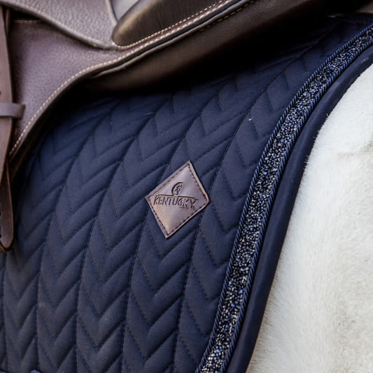 Close-up of a quilted equestrian saddle pad with 'Kentucky' branding.