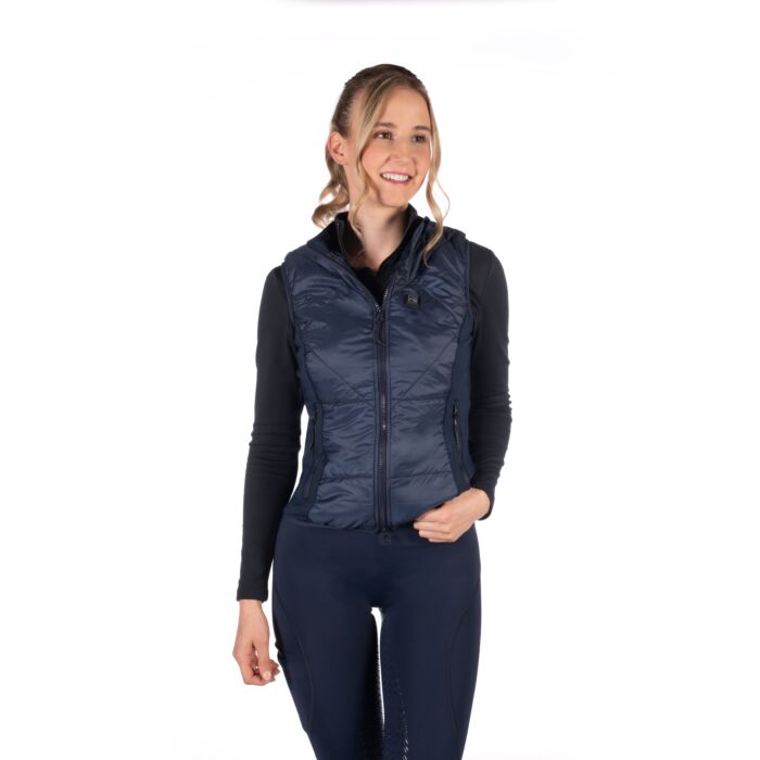 Woman wearing a navy puffer vest on a white background