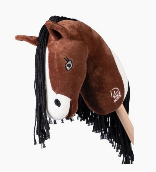 Plush horse head toy with forelock on a white background