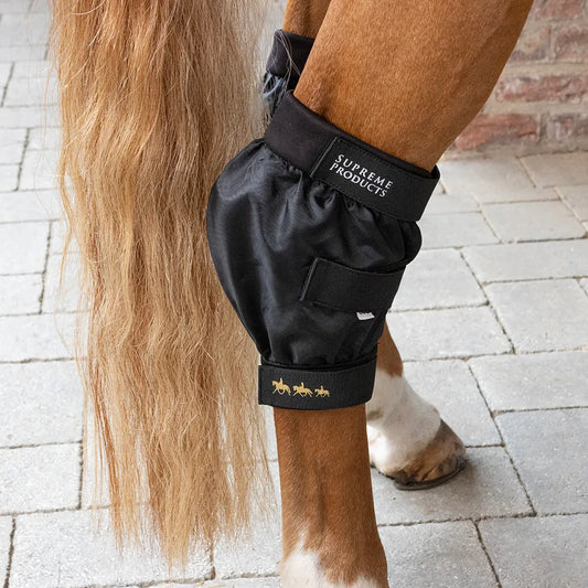 Black protective leg wrap on a horse's leg with 'Supreme Products' branding.