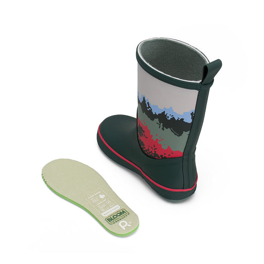 Green kids wellington boot with an insole on the side on a white background