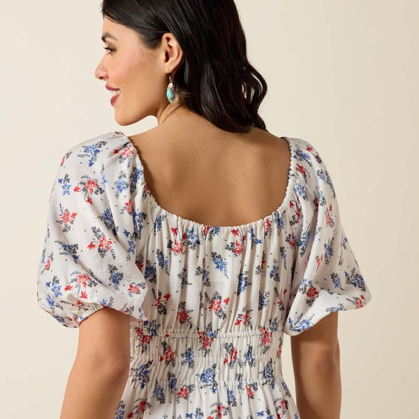 Woman wearing a floral dress with a beige background