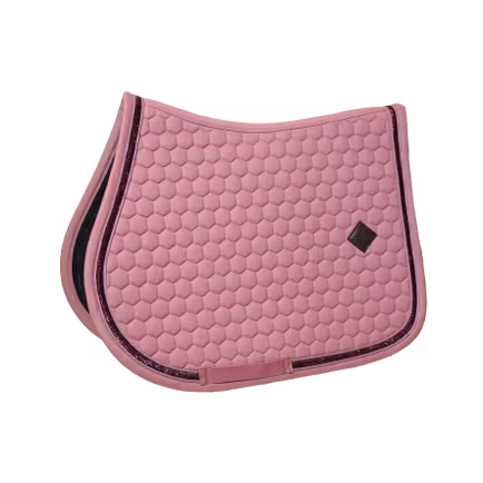 Pink quilted saddle pad with black border on a pink background