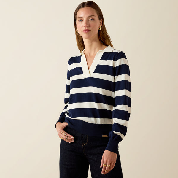 Woman wearing a navy and white striped sweater against a beige background