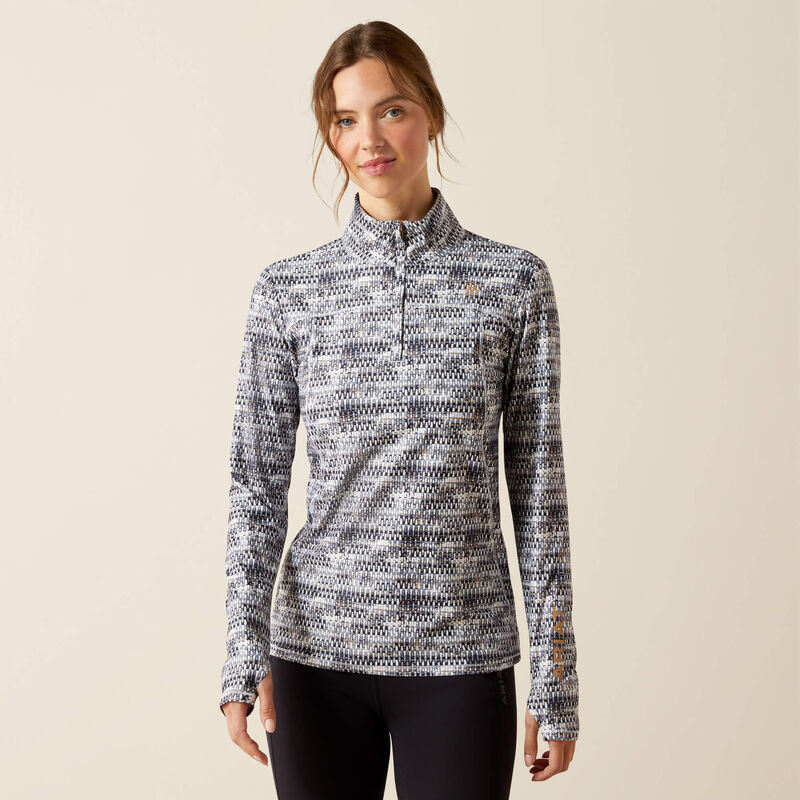 Woman wearing a patterned long-sleeve shirt on a beige background