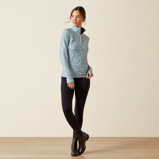 Woman wearing a blue patterned shirt against a beige background