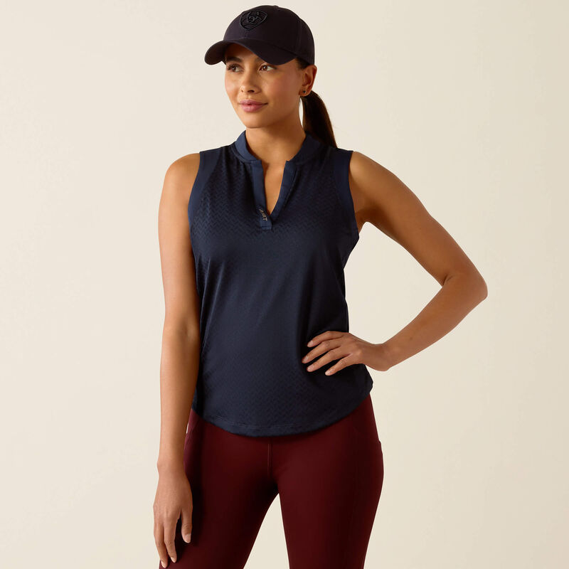 Woman wearing a navy sleeveless top and maroon leggings on a beige background