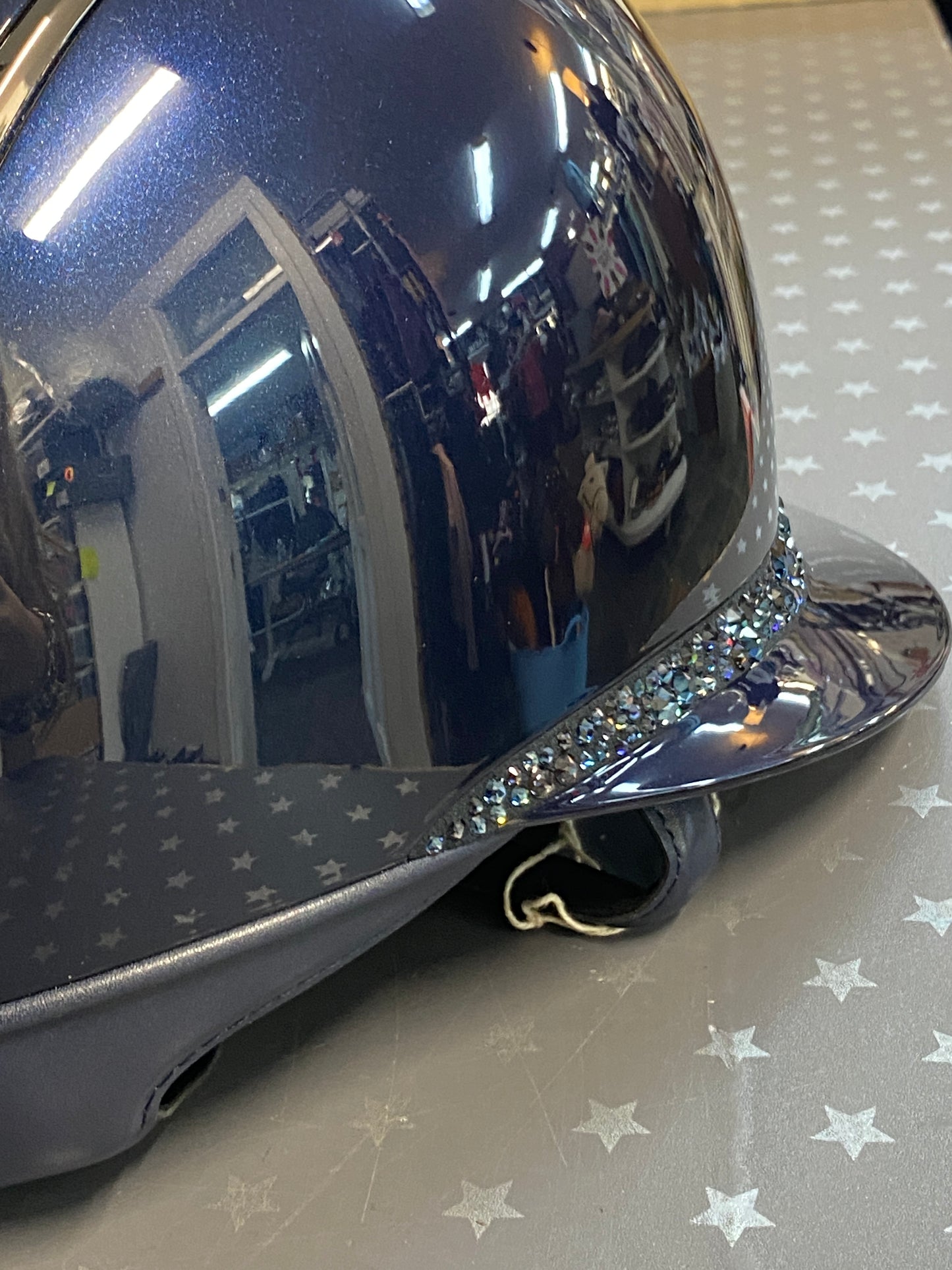 Close-up of a glossy samshield helmet with a star-patterned background