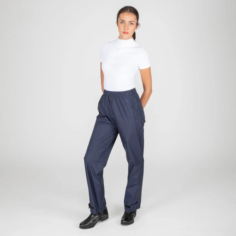 Woman wearing navy pants and a white top on a white background