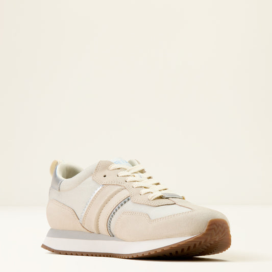 Beige sneaker with brown sole on a light beige background