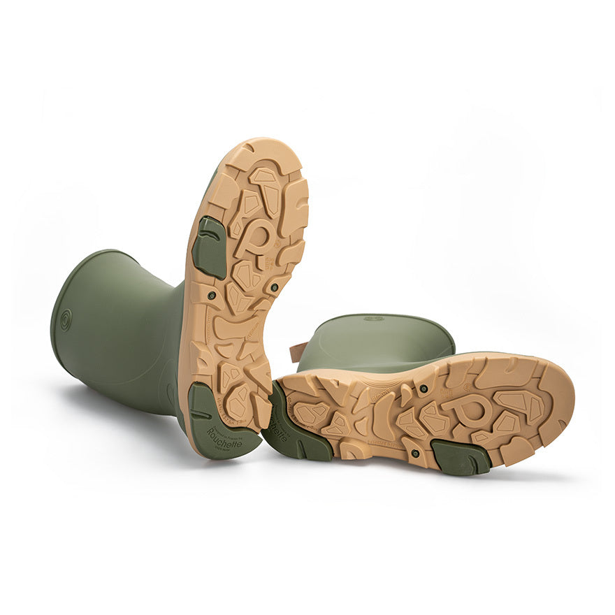 Close-up of green rubber boots with tan soles on a white background