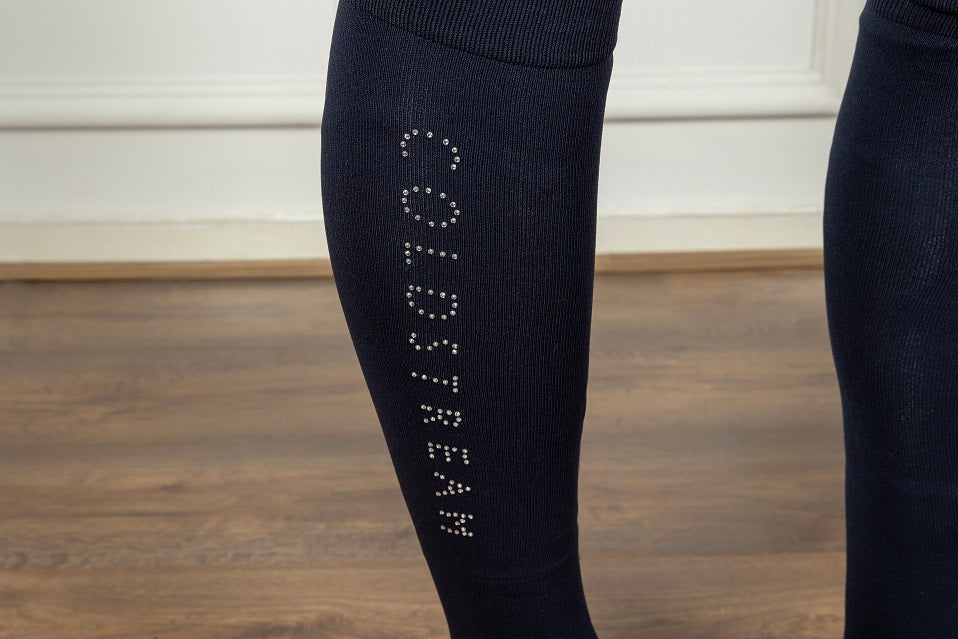 Navy socks with 'Coldstream' text on a wooden floor