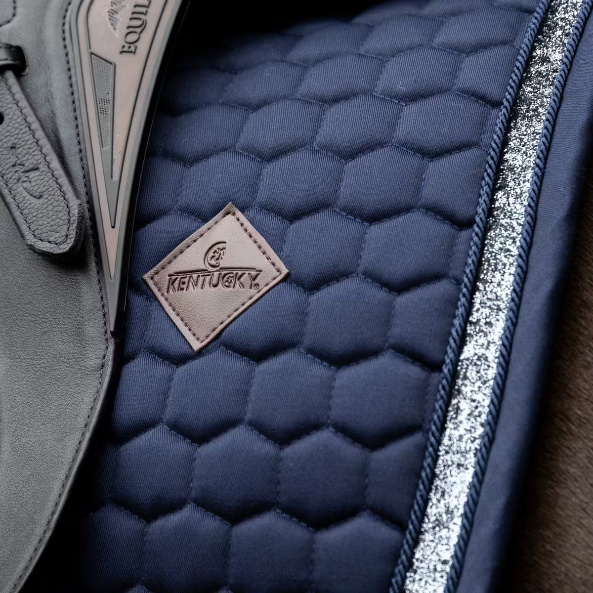Detail of a navy glitter saddle pad on a horse