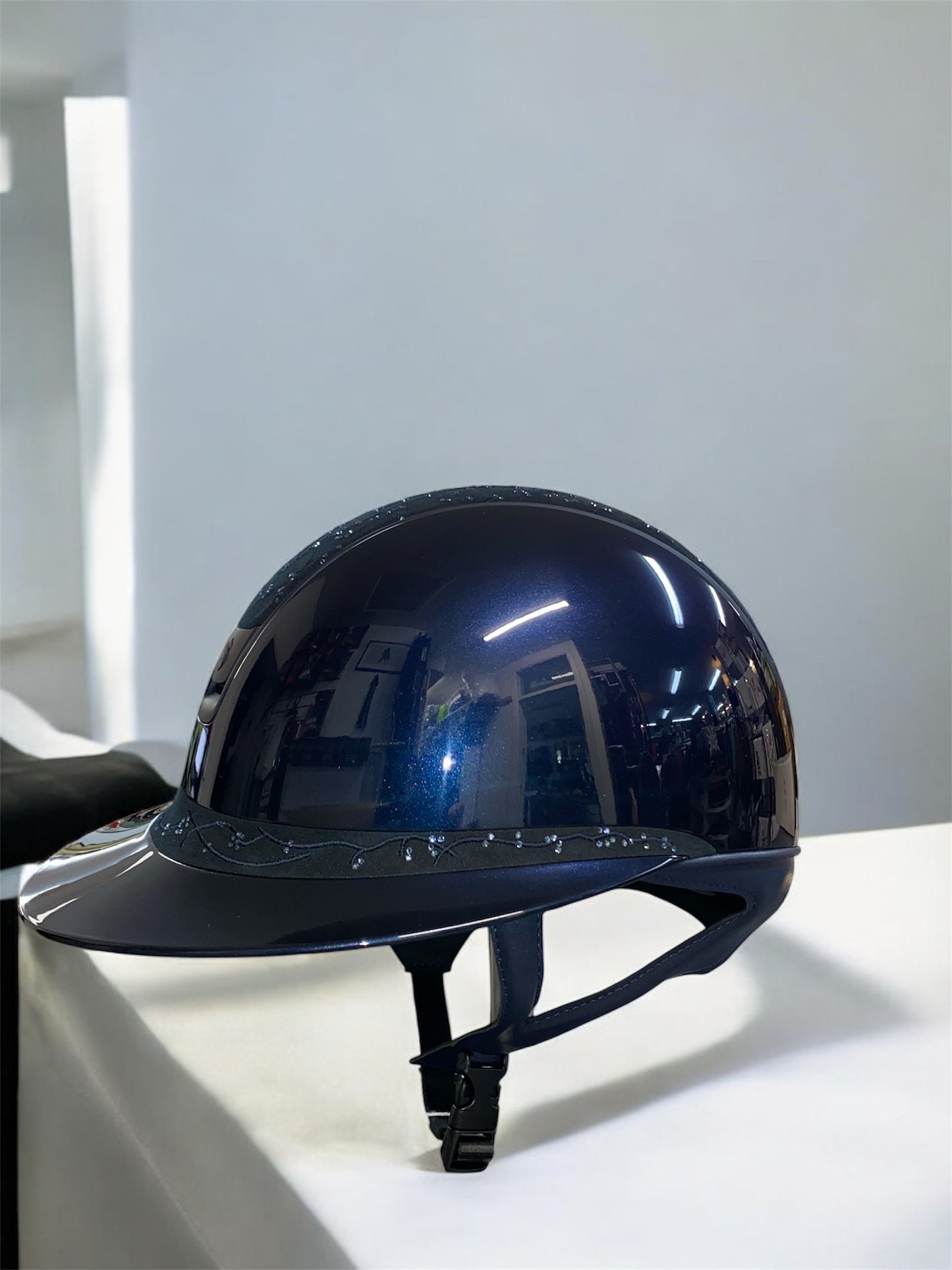 Blue helmet on a white surface with a light gray background