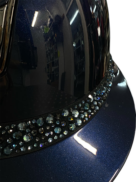 Close-up of a blue helmet with decorative crystals on a white background
