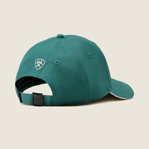 Teal baseball cap with a logo on the side against a beige background