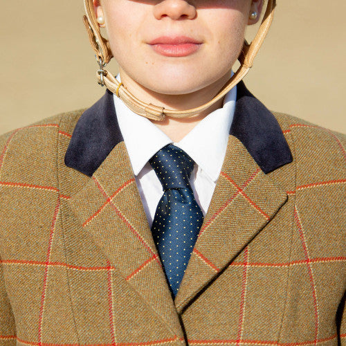 Person wearing a blue tie with yellow polka dots