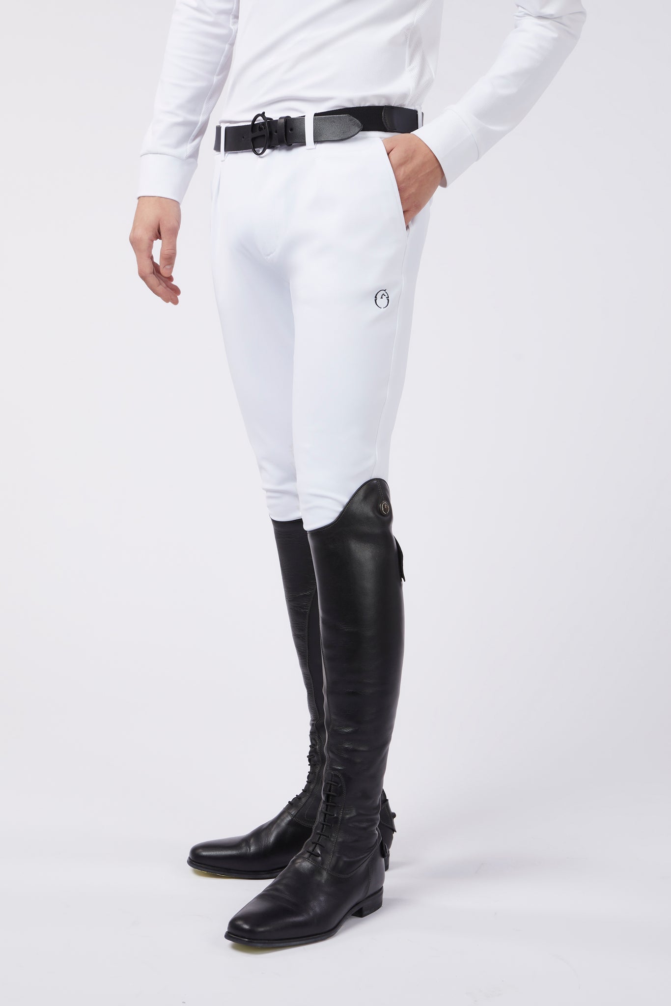 Man wearing white competition breeches and black riding boots 