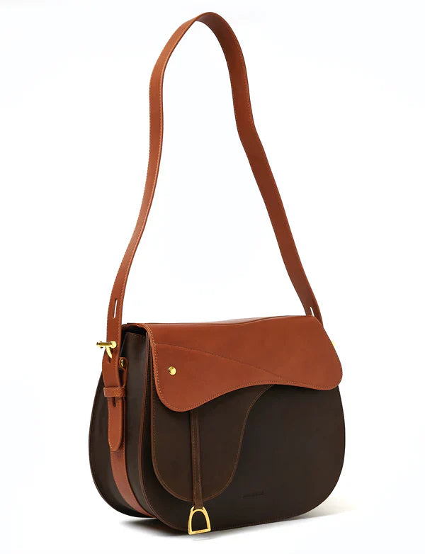 Stylish leather handbag in the shape of a saddle on a white background
