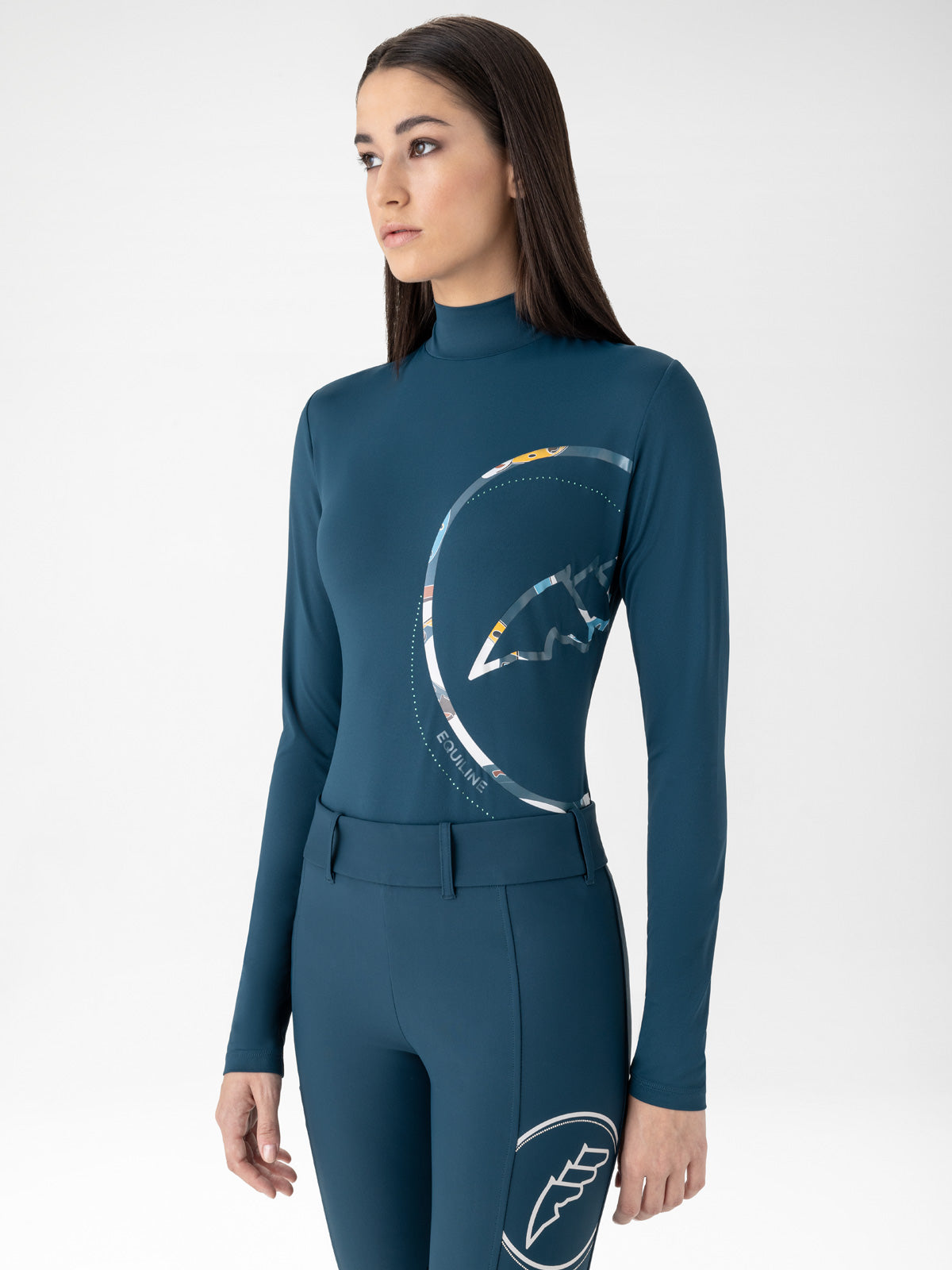 Woman wearing Equiline Eblec second skin top and matching leggings in Legion Blue – sleek technical equestrian wear from Boomerang.ie Autumn Winter 2025