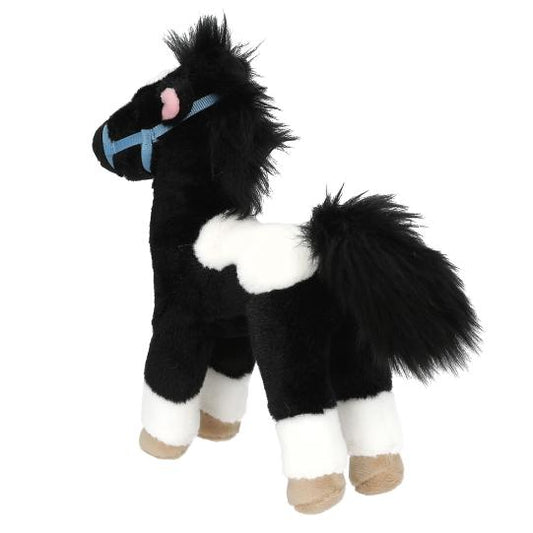 Black and white plush horse toy with a blue bridle on a white background