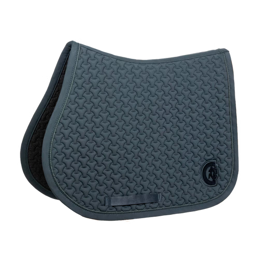 Green saddle pad on a plain background