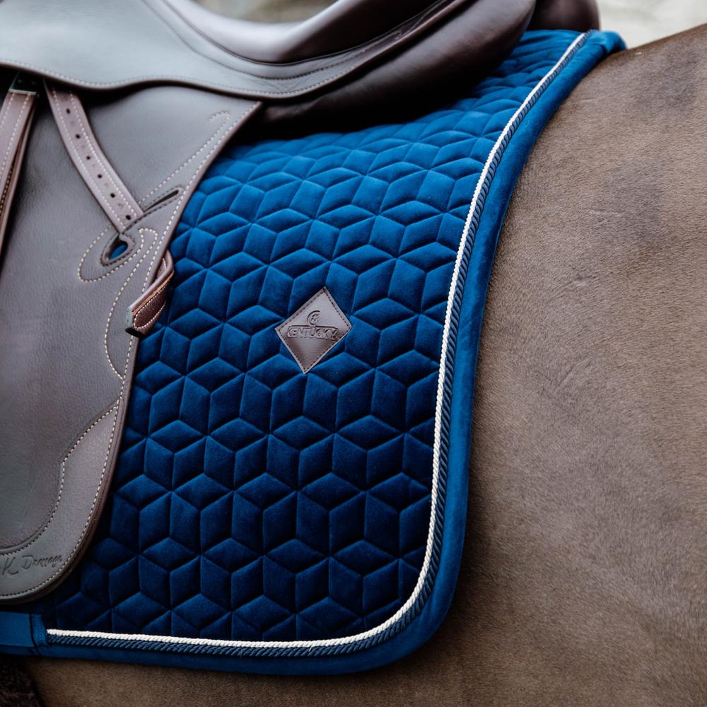 Navy saddlepad on a horse under a brown saddle