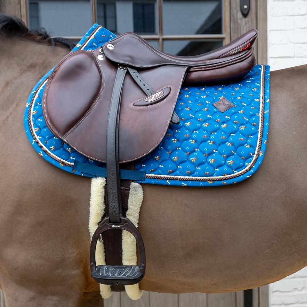 Navy saddle pad under a brown saddle on a brown horse