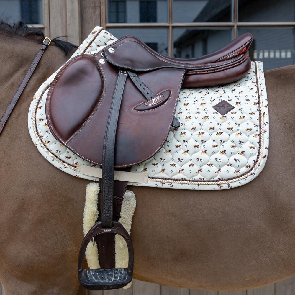 Beige saddle pad under a brown saddle on a brown horse
