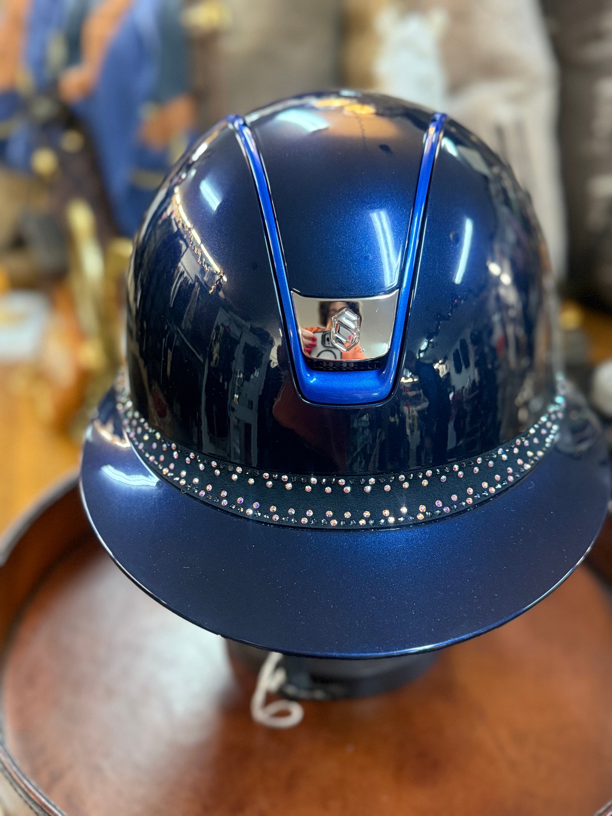 Blue helmet with decorative elements on a wooden surface
