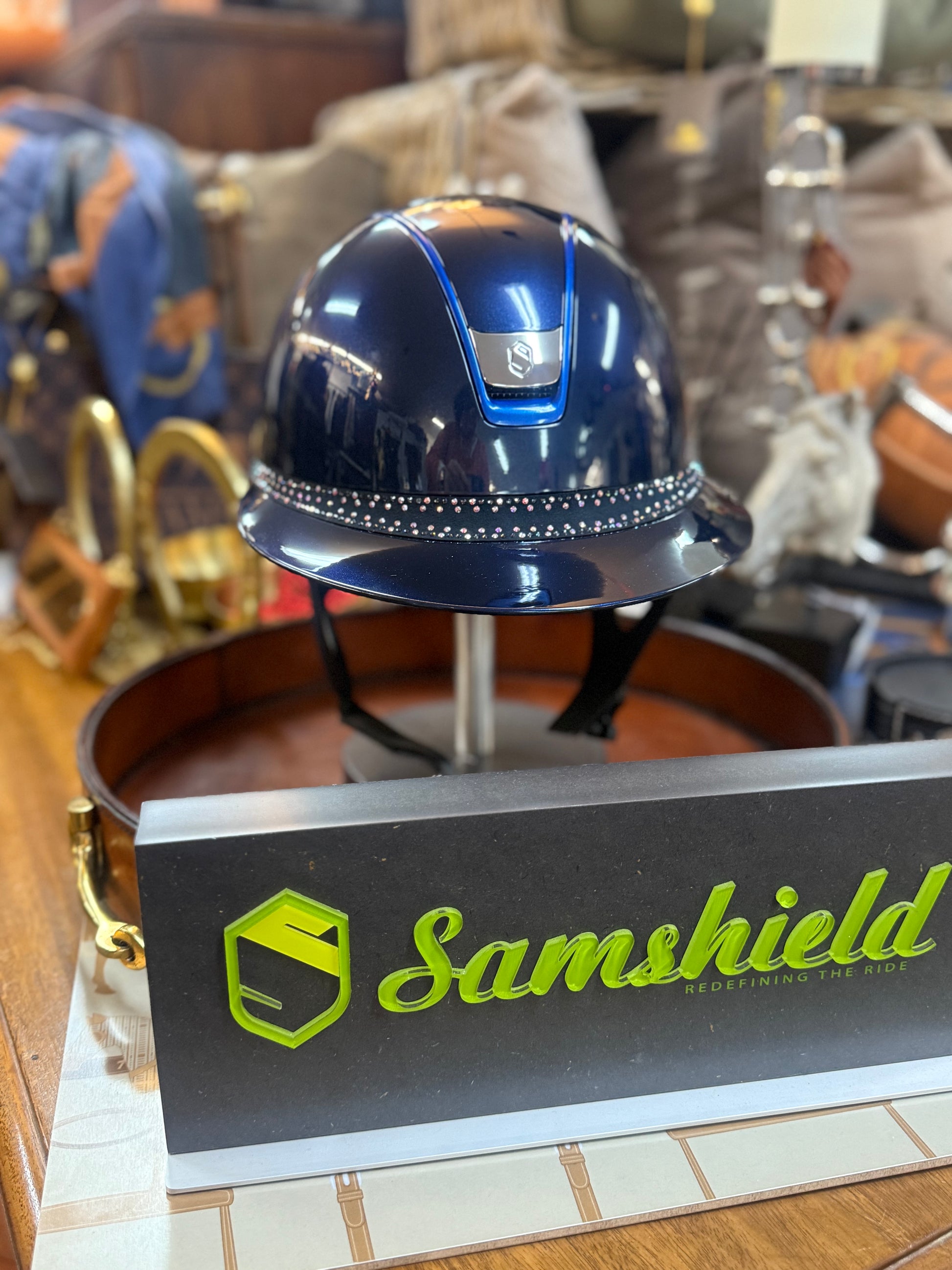Blue hard hat on a stand with Samshield branding in the foreground