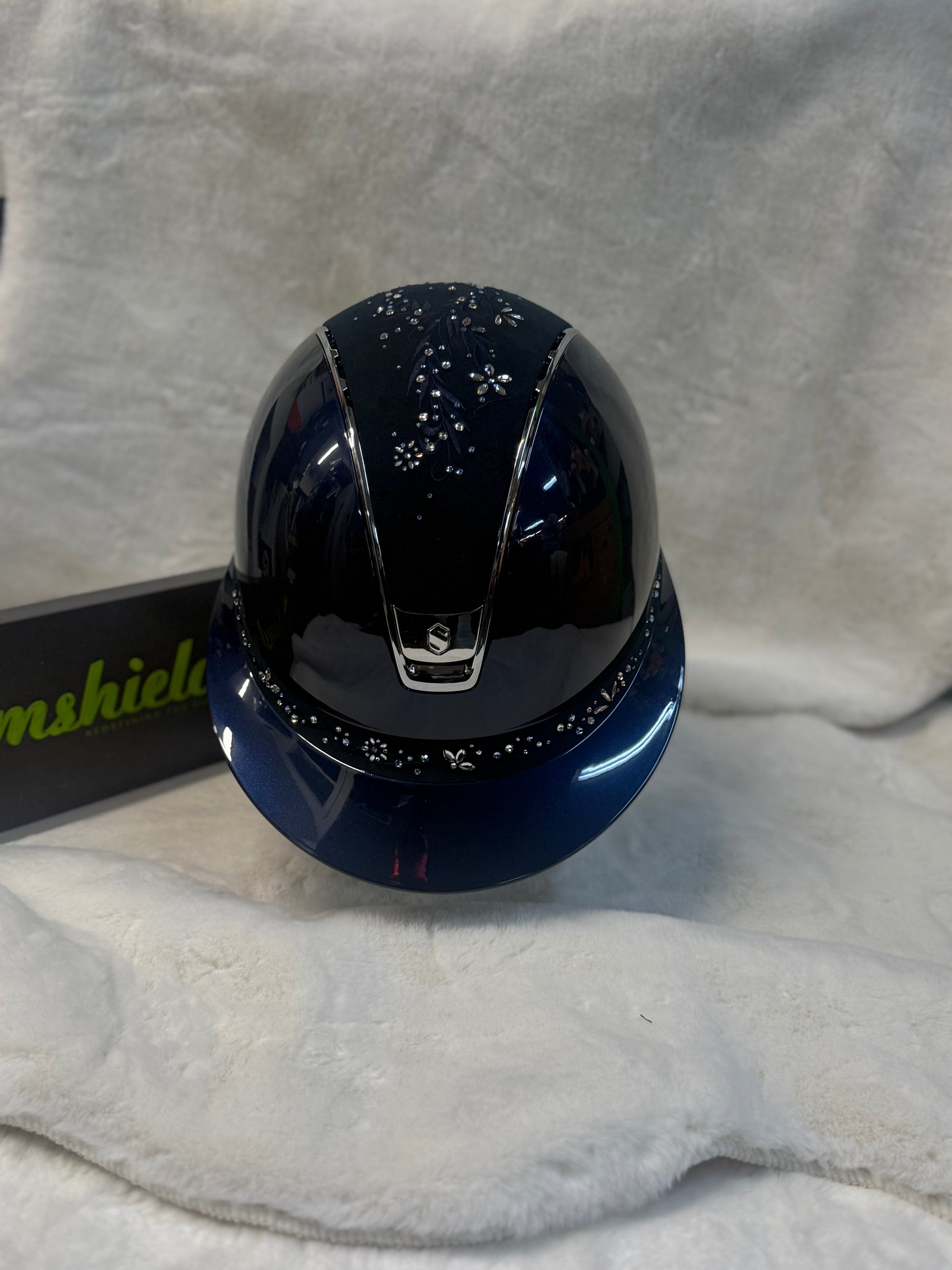 Navy helmet with decorative elements on a gray fabric background