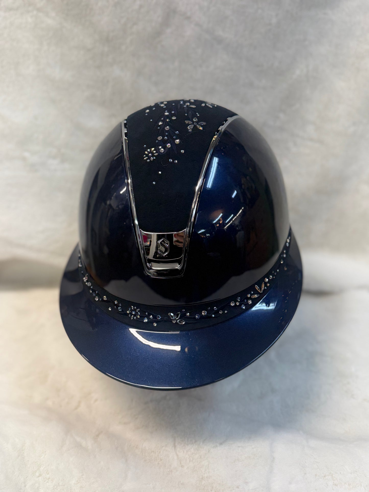 Blue helmet with decorative elements on a light background