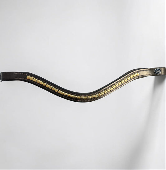 A browband with a wavy, S-shaped curve, featuring a row of gold-toned rectangular studs or metallic accents along the center and a small circular blue emblem near the bottom.