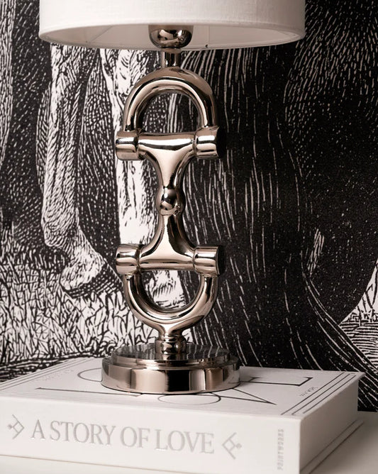 Silver bit lampstand on a book