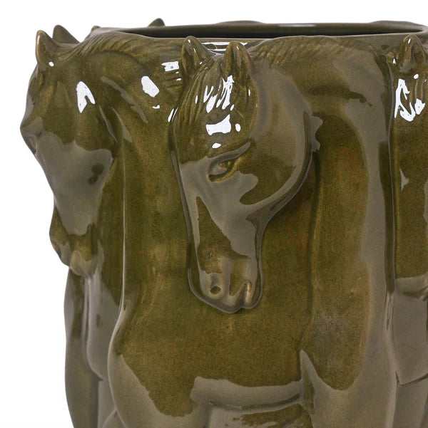 Green ceramic vase with horse heads on a white background