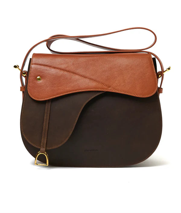 Equestrian saddle shaped handbag on a white background