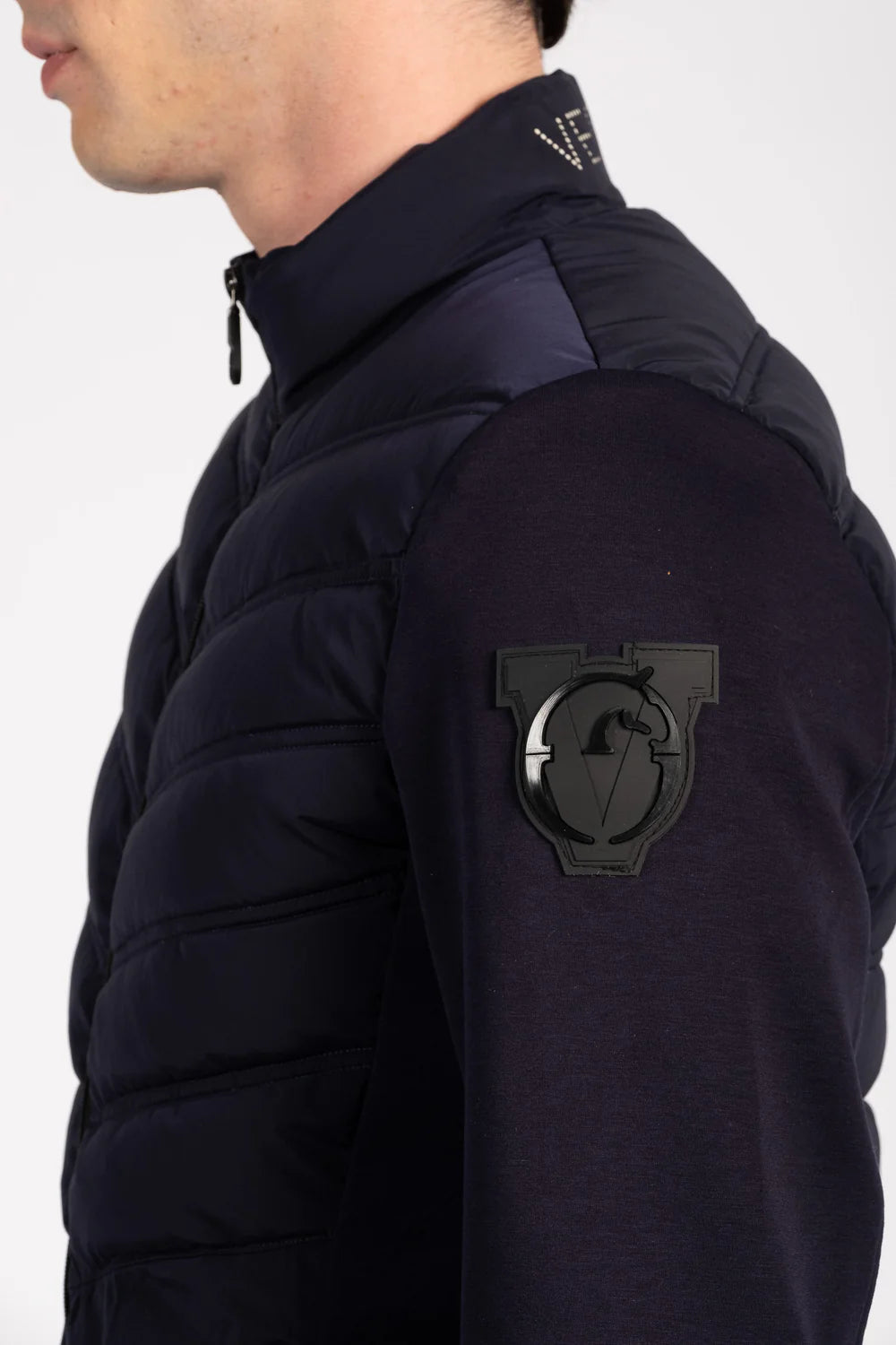 Navy jacket with a patch on the sleeve against a white background