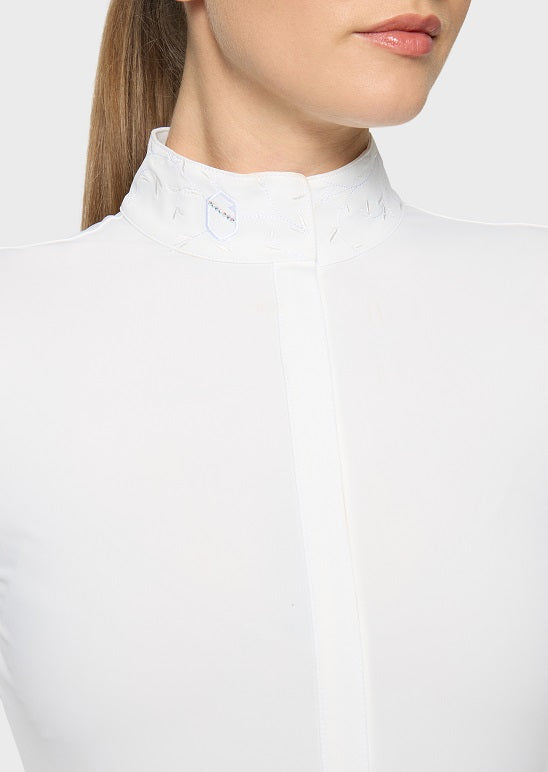 Close-up of a model wearing a white high-neck long-sleeve top with subtle tonal embroidery on the collar.