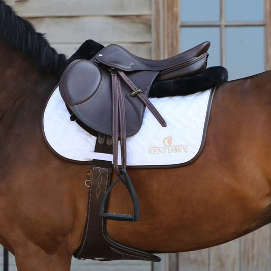 Brown saddle on a horse with a white blanket featuring 'Kentucky' branding.